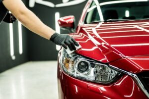 Car Service Workers in Baltimore, MD, Apply Ceramic Coating to a Car for Shine and Durability.